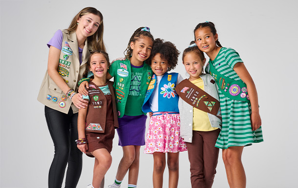 Six Girl Scouts of various ages sitting on a couch together Six Girl Scouts of various ages sitting on a couch together